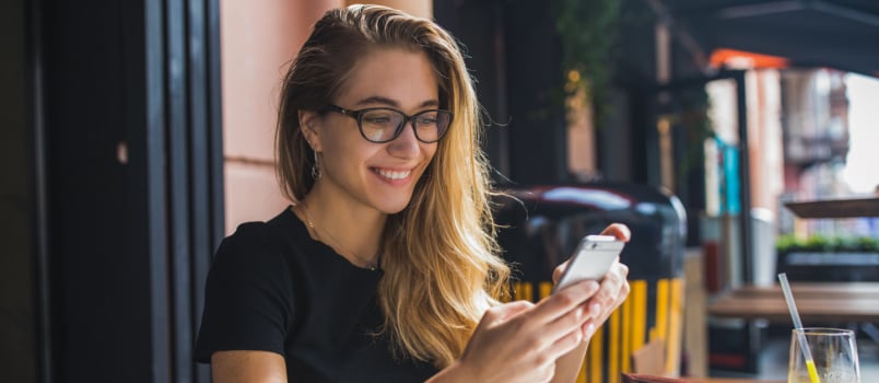 Woman smiling while texting