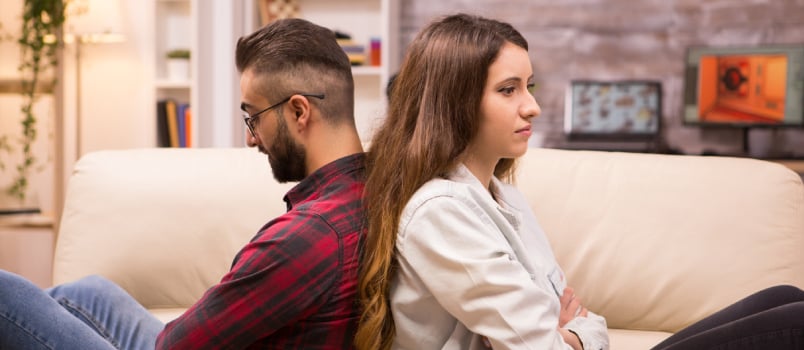 Couple sitting back to back