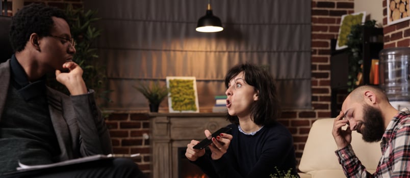 Unhappy wife showing husband proof of cheating