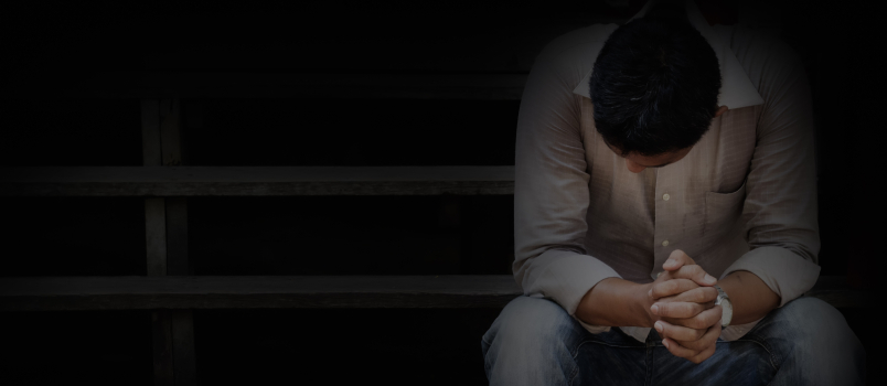 Man sitting alone on stairs