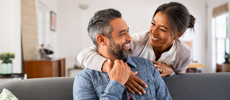 Women hugging man from back