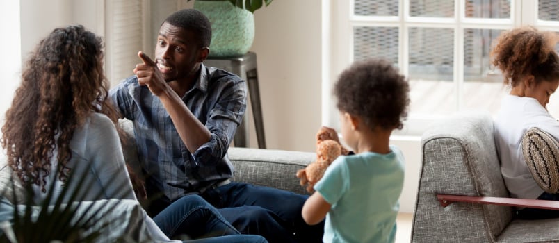 Unhappy couple quarrelling at home