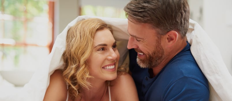 Happy couple relaxing in bed