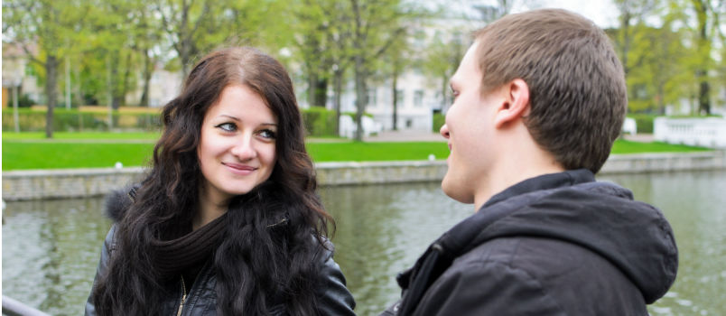 Couple sitting near pond lake