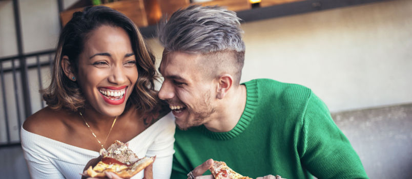 Couple eating pizza together