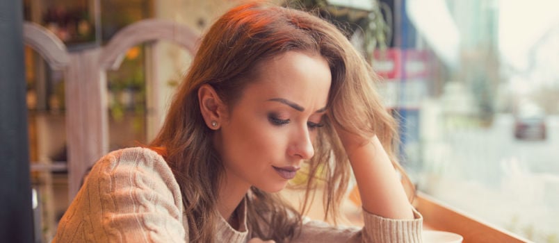 Young women sitting on coffee table