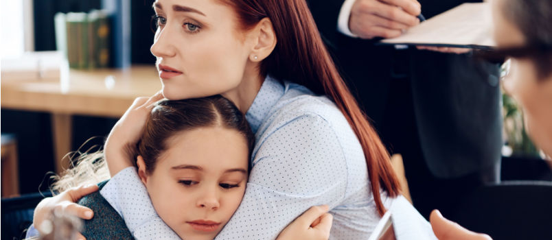 Sad women hug little upset girl