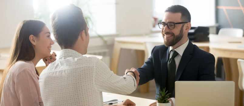 Smiling lawyer meeting with couple
