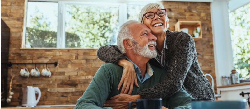 Old women hugging her husband