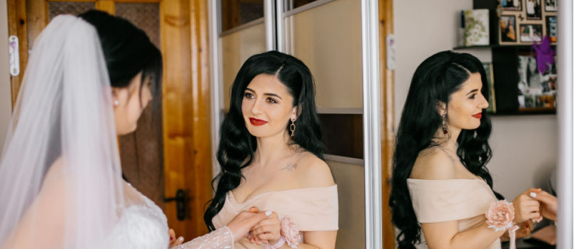 Bride maid helping her