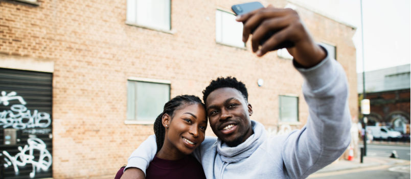 Couple taking selfie outside