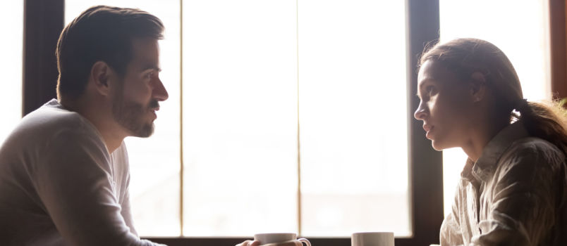 Couple sitting on coffee table