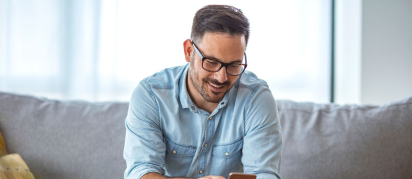 Spectacle man relaxing on couch