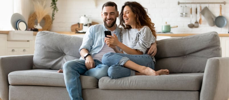 Happy couple sitting on couch 