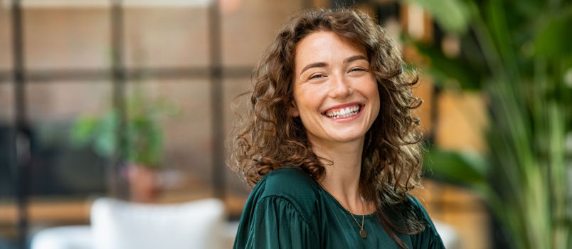 Young smiling woman looking into camera