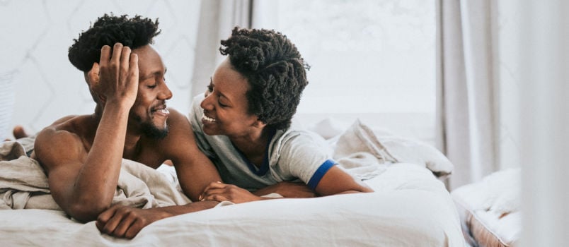 Cute happy couple playing bed