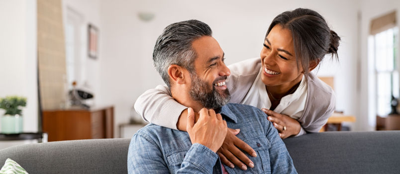 Smiling women hugging man