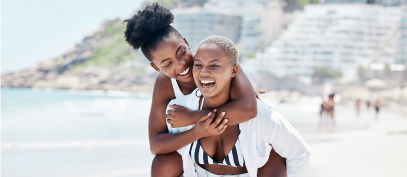 Lesbian couple walking on beach
