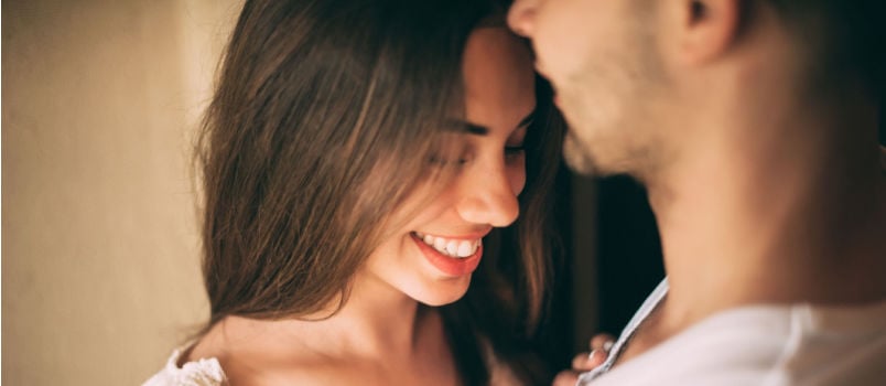 Man kissing women on forehead 