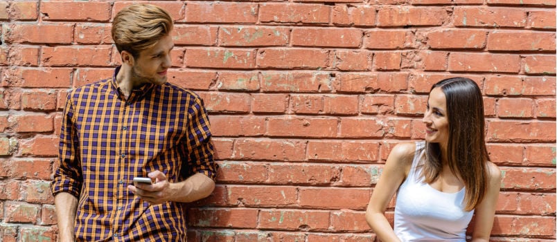 Cheerful couple talking on street