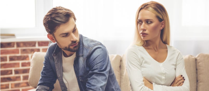 Couple sitting back to back not talking with each other