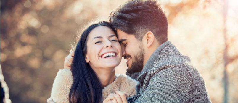 Young couple hugging outside