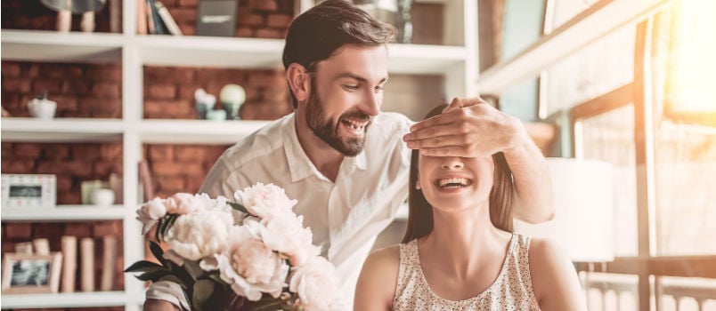 Man surprising women with flowers