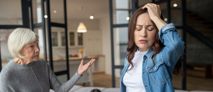 Concerned Woman with Arguing Senior and Child Indoors