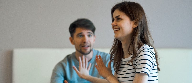 Cheerful woman and man surprised on couch