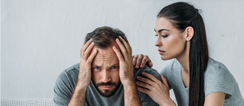 Women supporting depressed man