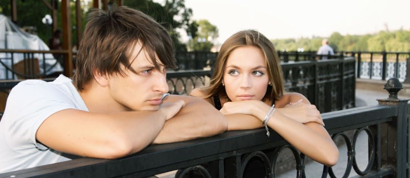 Man and women leaning on grill