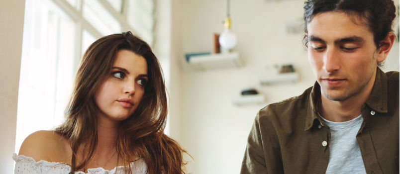 Women looking unhappy while looking at man