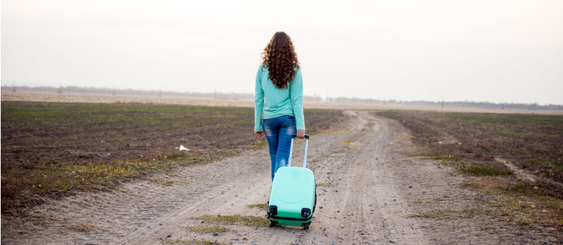 Young women walking alone on road