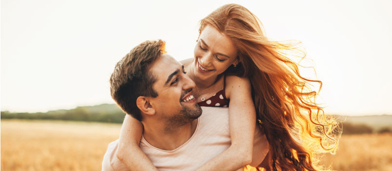 Women hugging man from back