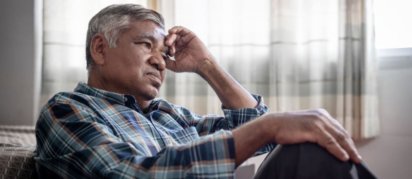 Senior depressed man sitting alone