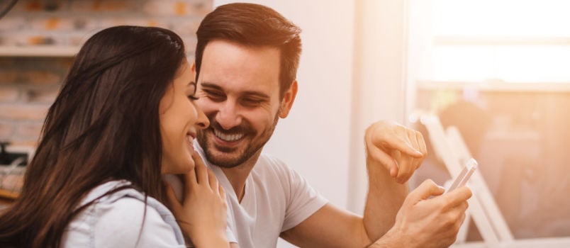 Young couple sitting looking at each other