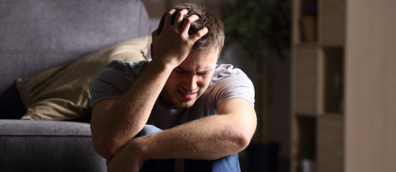 Sad man sitting on floor