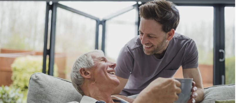 Man leaning over couch