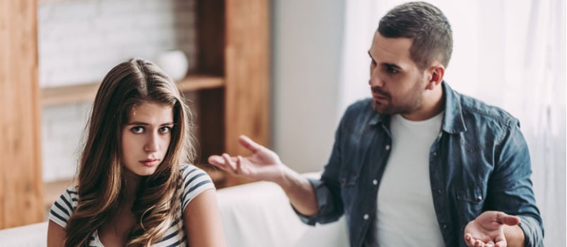 Upset couple sitting on couch