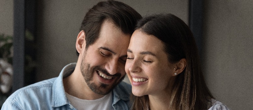 Couple embracing sitting together