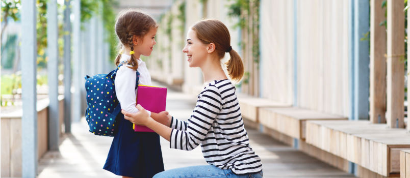 Mother leaving her daughter to school