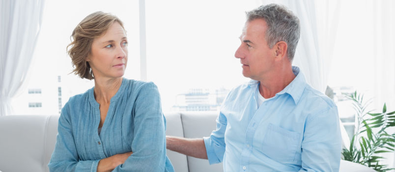 Aged couple sitting on couch