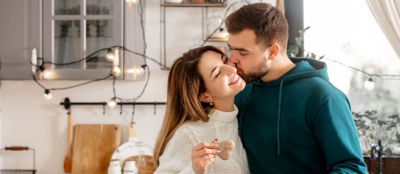 Happy couple cocking in kitchen
