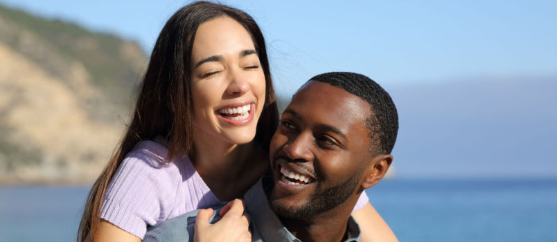 Happy interracial couple laughing together