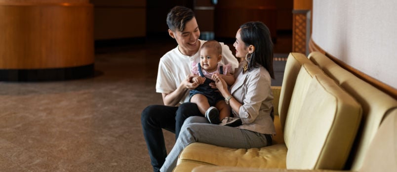 Asian couple playing with baby
