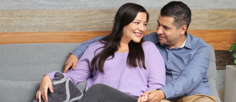 Man and woman sitting on couch