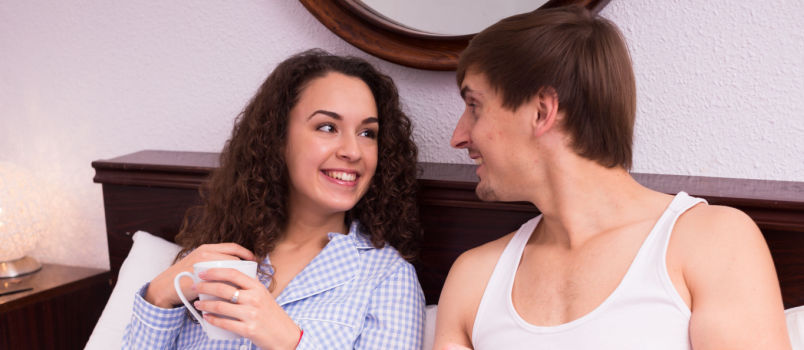 Couple talking in bed