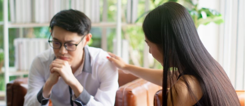 Woman comforting man