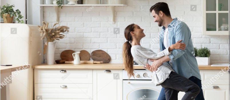 Couple dancing together in kitchen