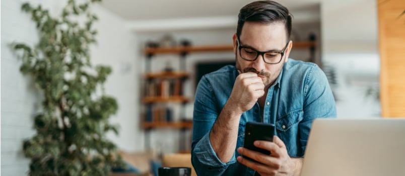Smart man looking at phone